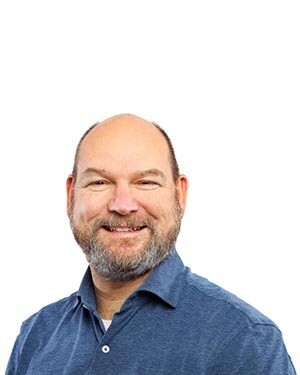 Roland Gort, medewerker bij DCP, lachend met armen over elkaar.